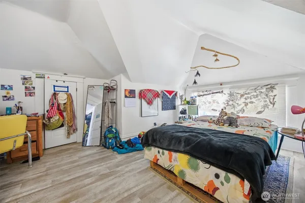 a bedroom with bed and a window