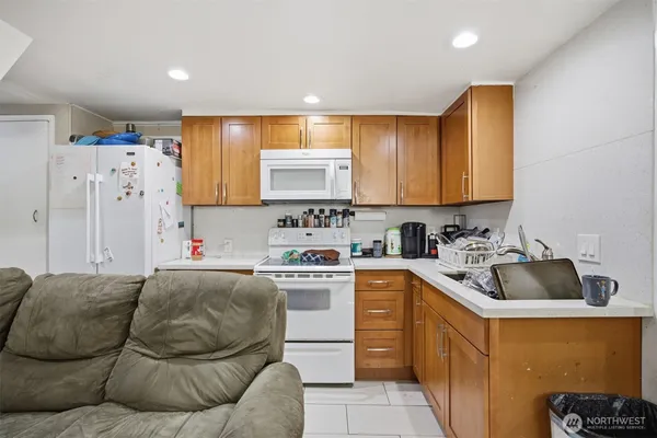 a kitchen with stainless steel appliances granite countertop a sink and a refrigerator