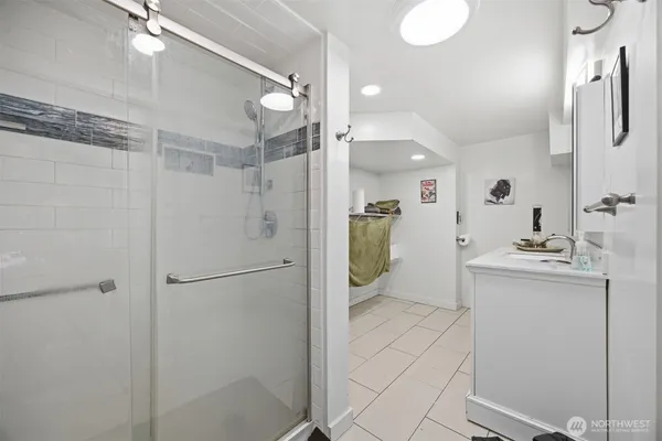 a bathroom with a shower sink and mirror