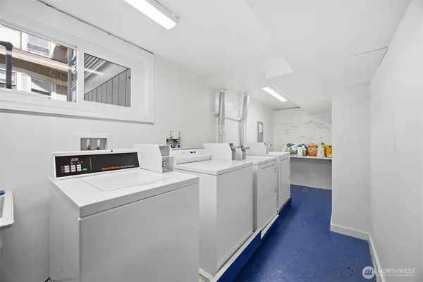 a kitchen with sink and white cabinets