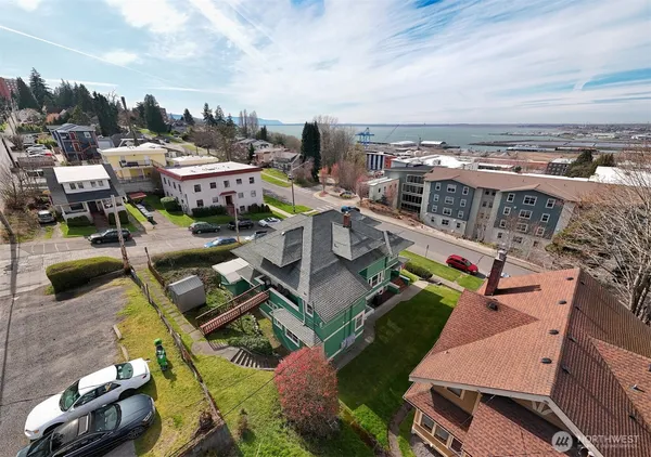 an aerial view of a house with a garden and lake view