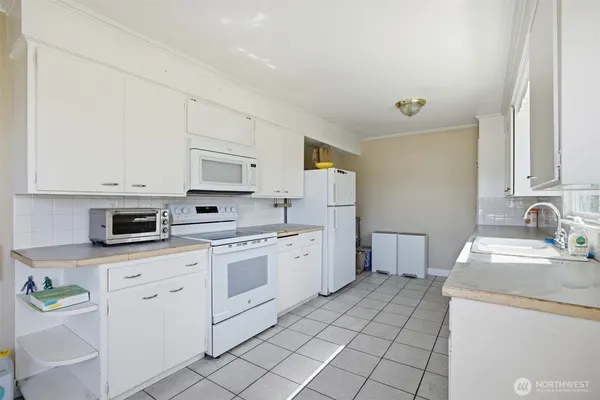 a kitchen with a sink stove and cabinets