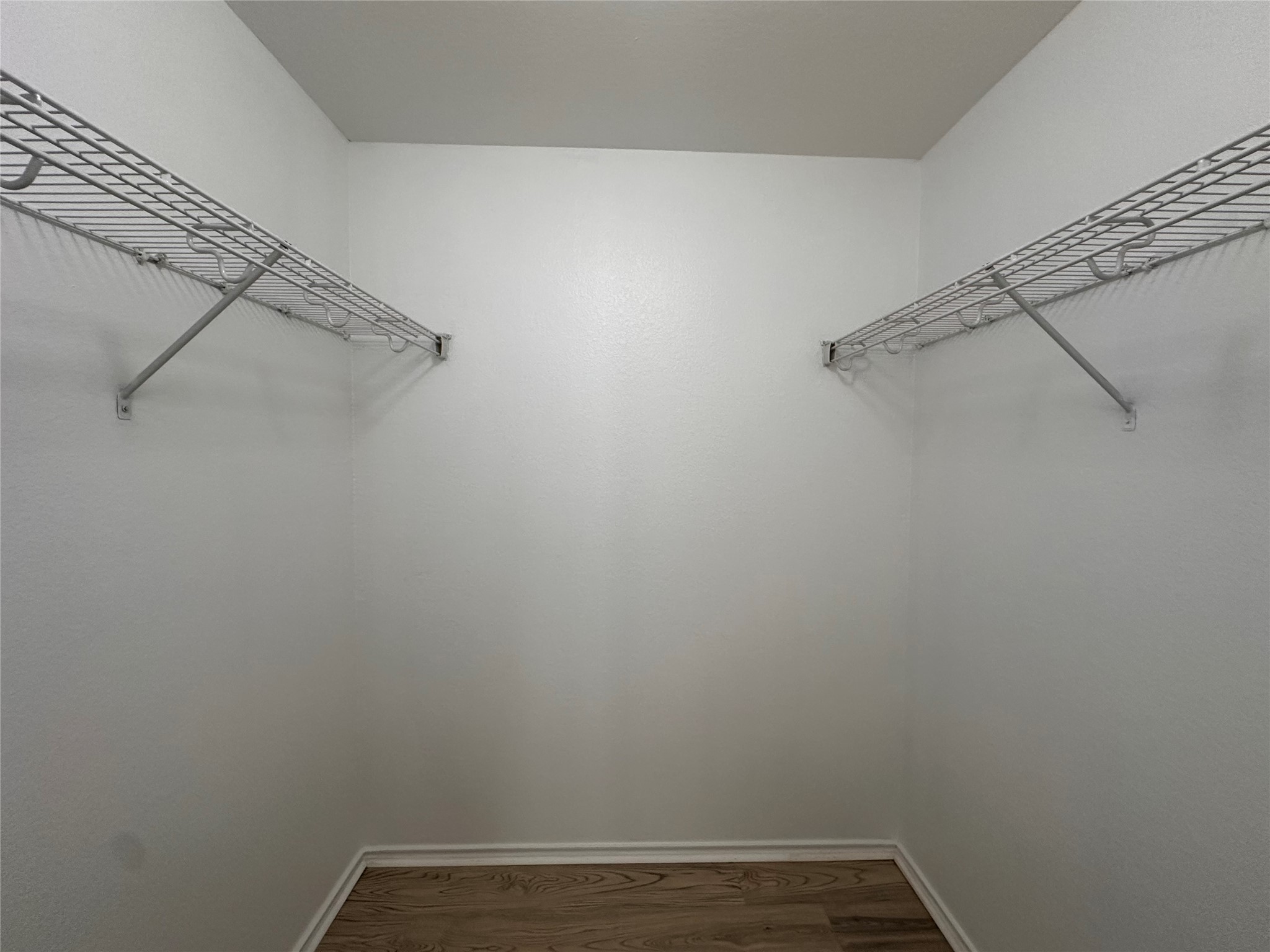722 Lavaca Loop Elgin, TX 78621 - Photo 20 of 24 Walk in closet featuring dark wood-type flooring