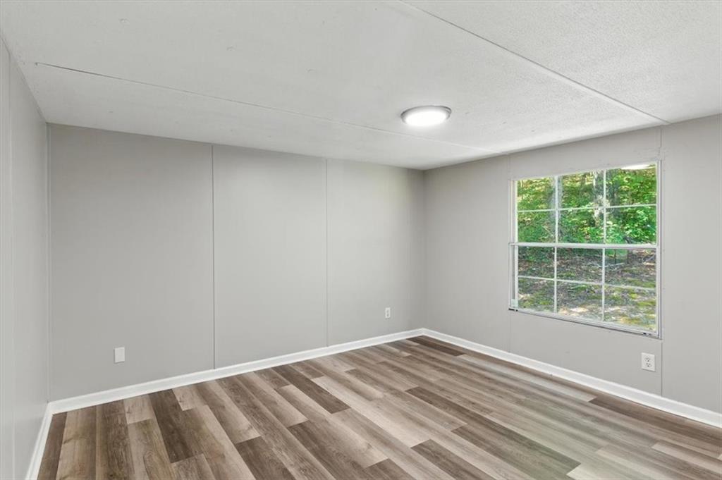 71 Kirk Road Northwest White, GA 30184 - Photo 19 of 74 an empty room with wooden floor and windows