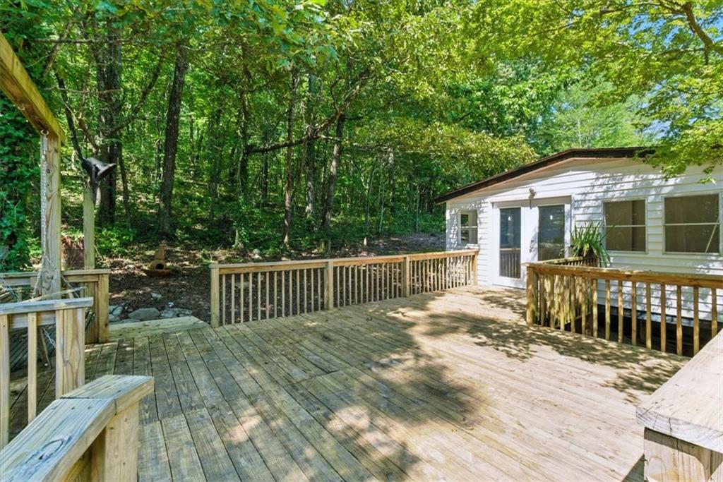 71 Kirk Road Northwest White, GA 30184 - Photo 27 of 74 a view of a deck with a chair and wooden floor
