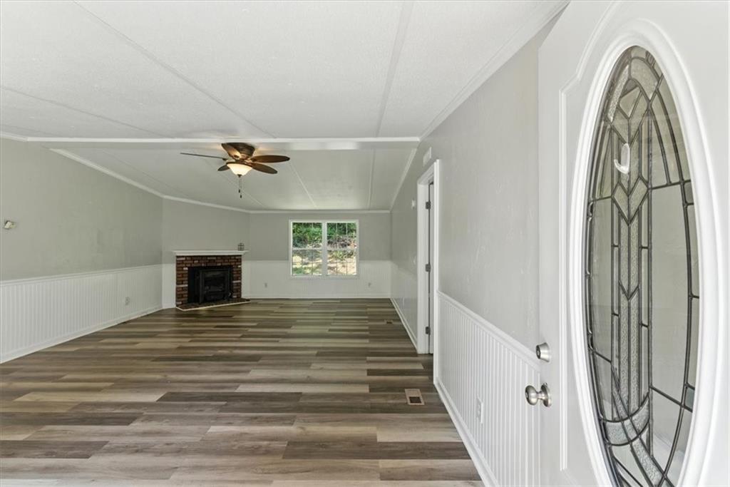 71 Kirk Road Northwest White, GA 30184 - Photo 4 of 74 a view of a livingroom with wooden floor and a ceiling fan