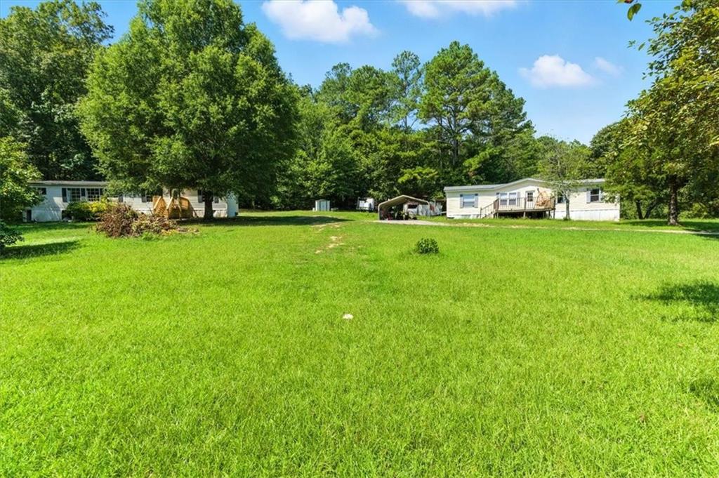 71 Kirk Road Northwest White, GA 30184 - Photo 73 of 74 a front view of a house with a yard