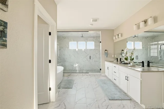 a bathroom with a granite countertop sink mirror bathtub and shower