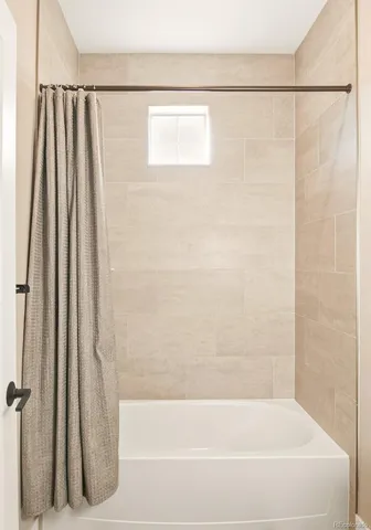 a bathroom with a shower curtain and a bathtub