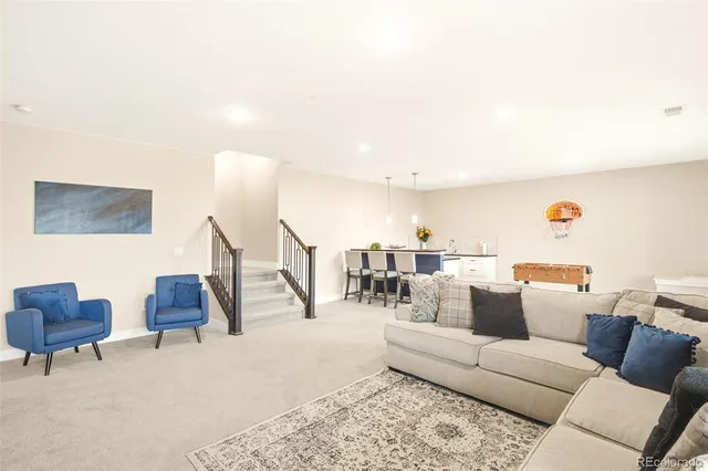 a living room with furniture and a lamp