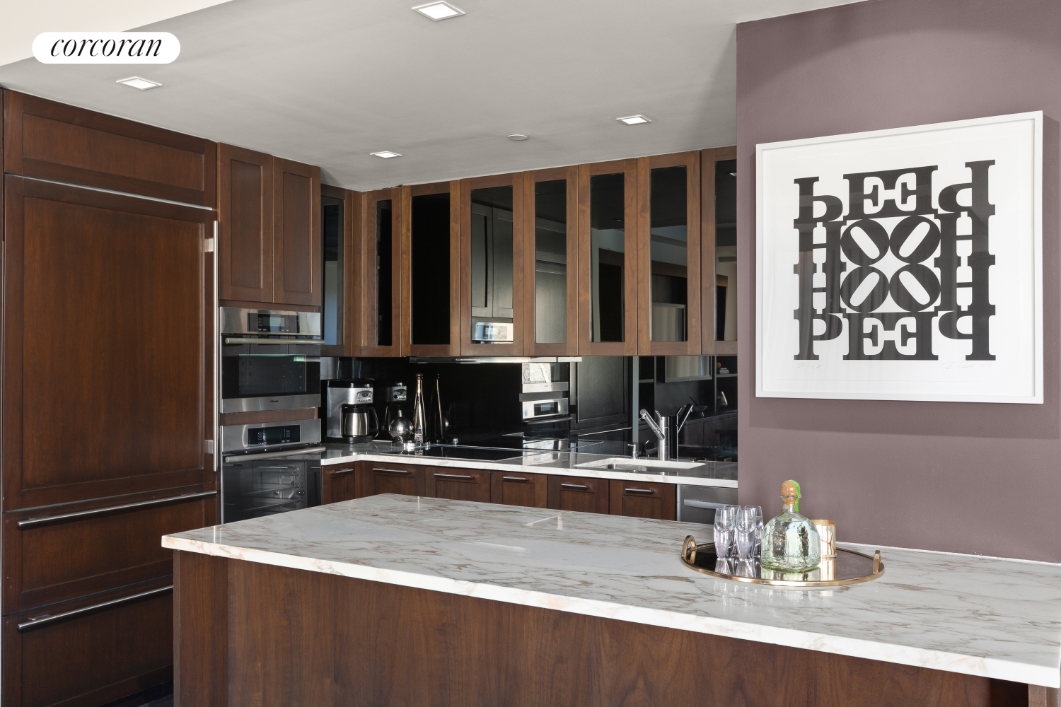 160 Central Park South, Unit 410 Manhattan, NY 10019 - Photo 4 of 17 a kitchen with stainless steel appliances a sink and cabinets