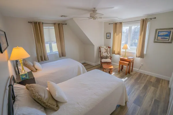 a bedroom with two beds and a chandelier
