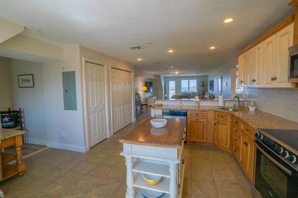 a kitchen with stainless steel appliances granite countertop a refrigerator and a stove top oven