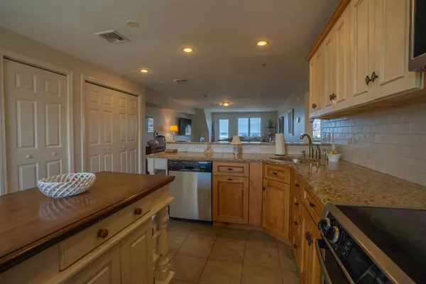 a kitchen with a sink appliances and cabinets