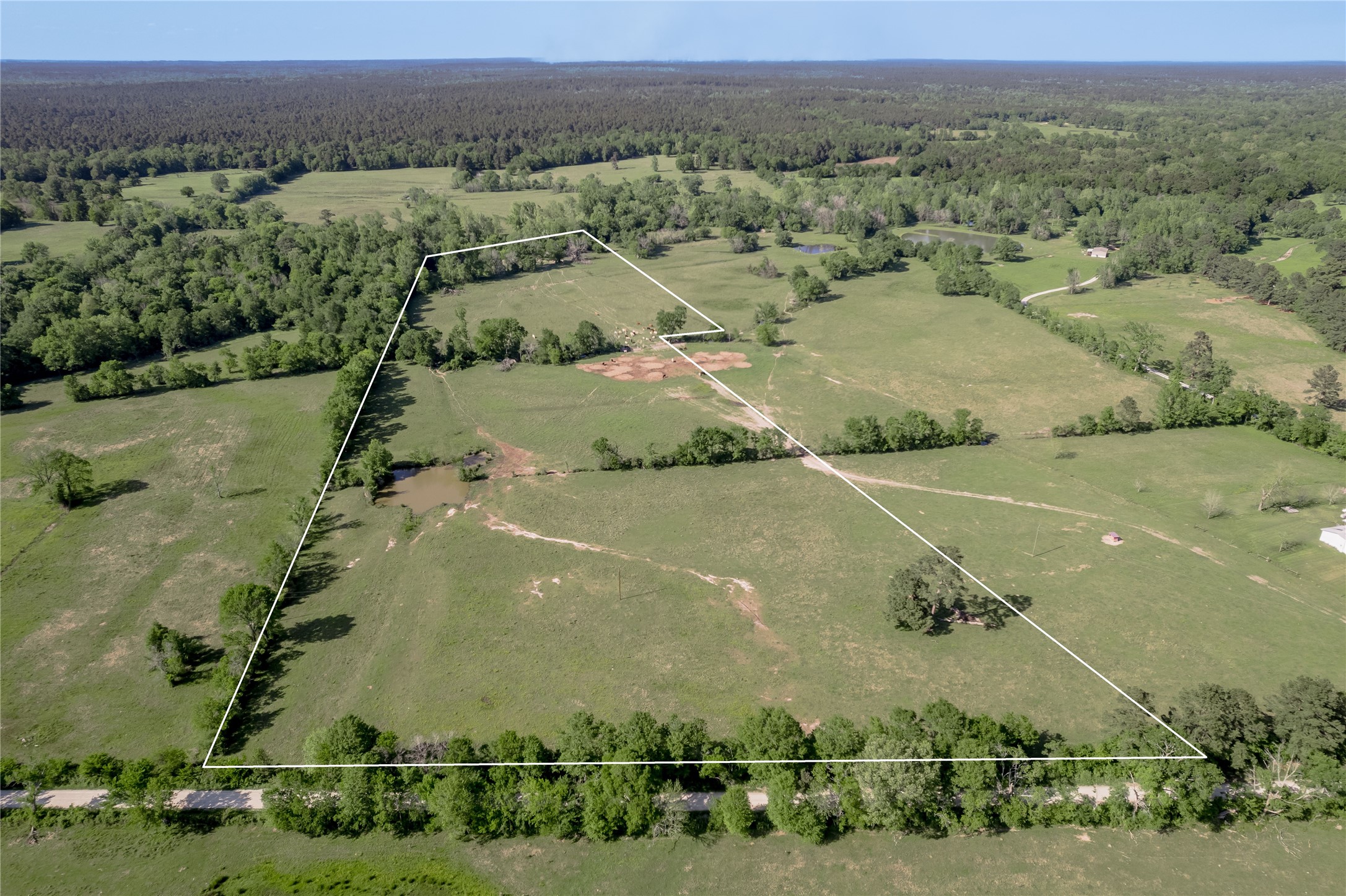 an aerial view of a houses with a yard