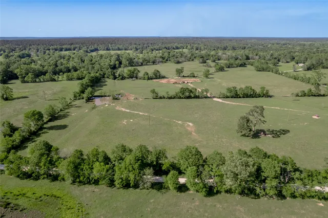 an aerial view of beach and residential houses with outdoor space