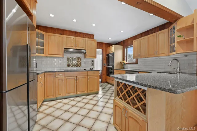 a kitchen with stainless steel appliances granite countertop a sink stove and cabinets