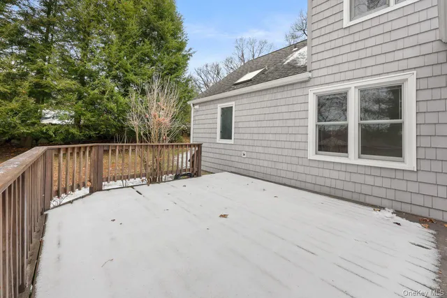 a wooden bench sitting in front of a house