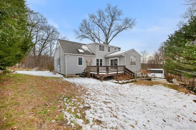 a front view of house with yard and trees around
