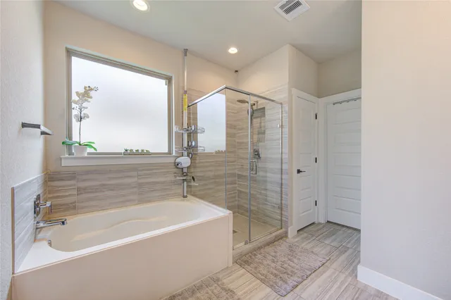 a bathroom with a bathtub and a shower