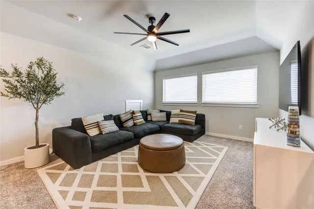 a living room with furniture a window and a chandelier