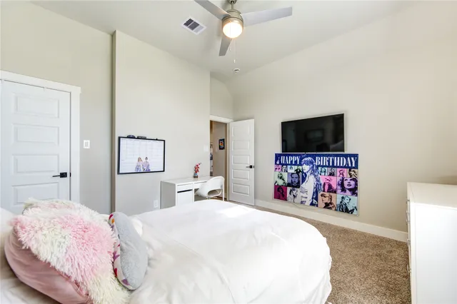 a bedroom with a bed and a flat screen tv