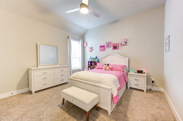 a bedroom with a bed and a dresser