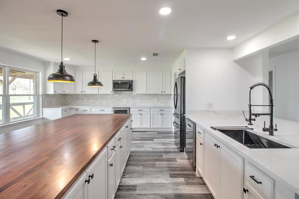 3884 Lois Road East Sanger, TX 76266 - Photo 14 of 40 Luxury Vinyl plank flooring, Farm style large kitchen sink.