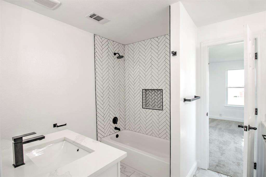 3884 Lois Road East Sanger, TX 76266 - Photo 20 of 40 Step in shower, white clean lines, with black fixtures.