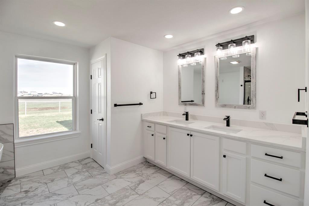 3884 Lois Road East Sanger, TX 76266 - Photo 30 of 40 Double sink vanity, with clean white cabinetry make the black fixtures pop!