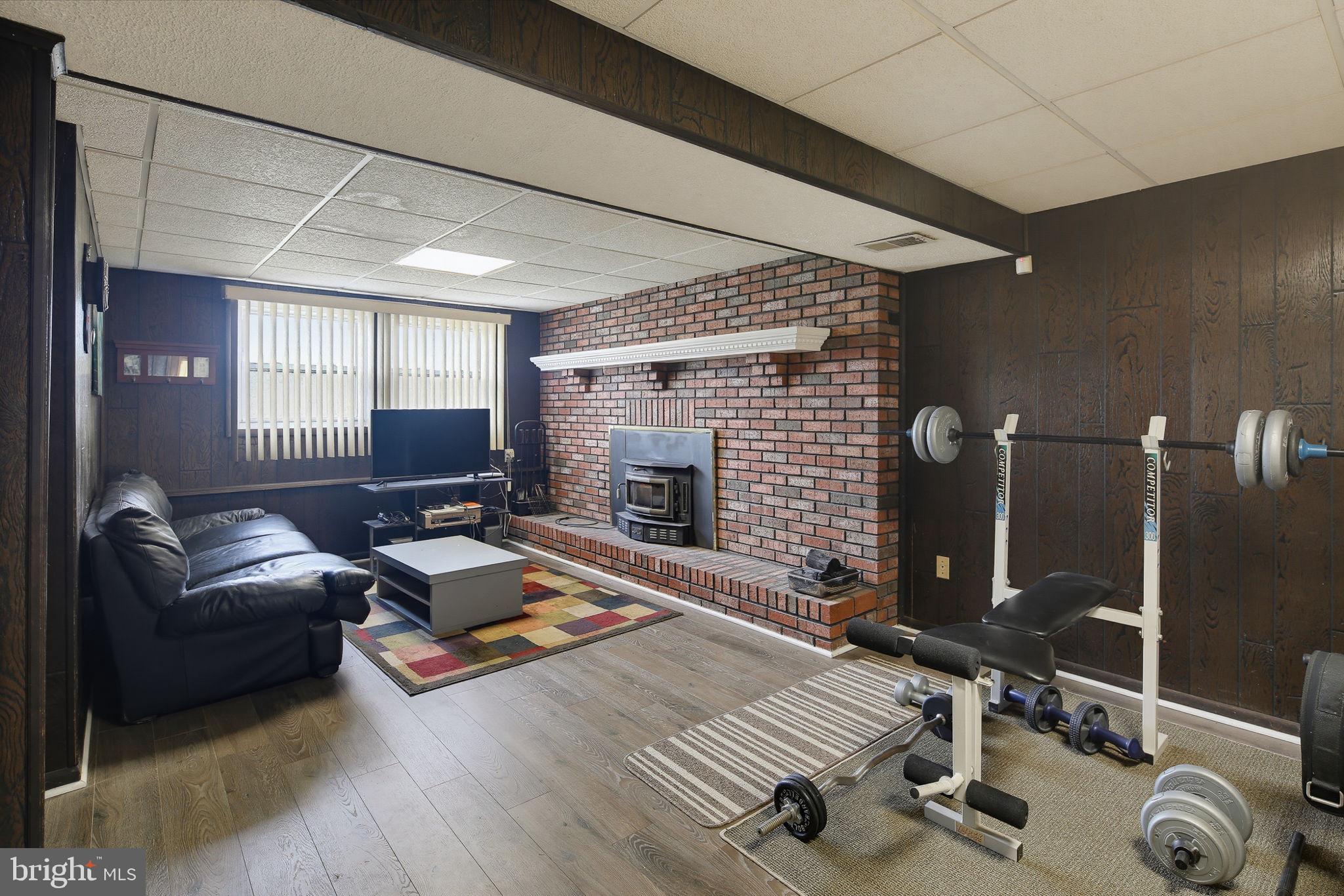 7802 Bastille Road Severn, MD 21144 - Photo 22 of 34 Cozy basement retreat with fitness area.