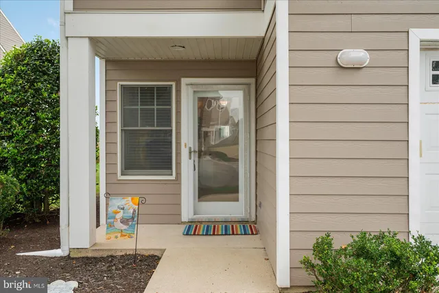 a living room with furniture kitchen view and a chandelier