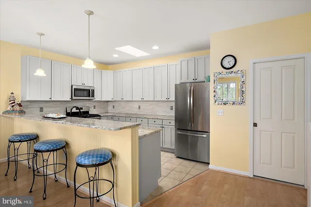 a view of a dining room with furniture wooden floor and chandelier