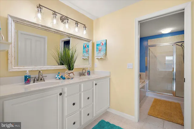 a bathroom with a sink a toilet and shower curtain