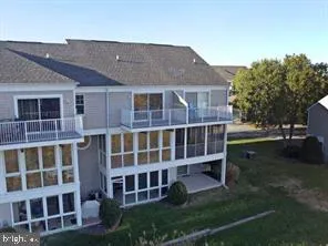 a view of a hallway with wooden floor windows and a livingroom