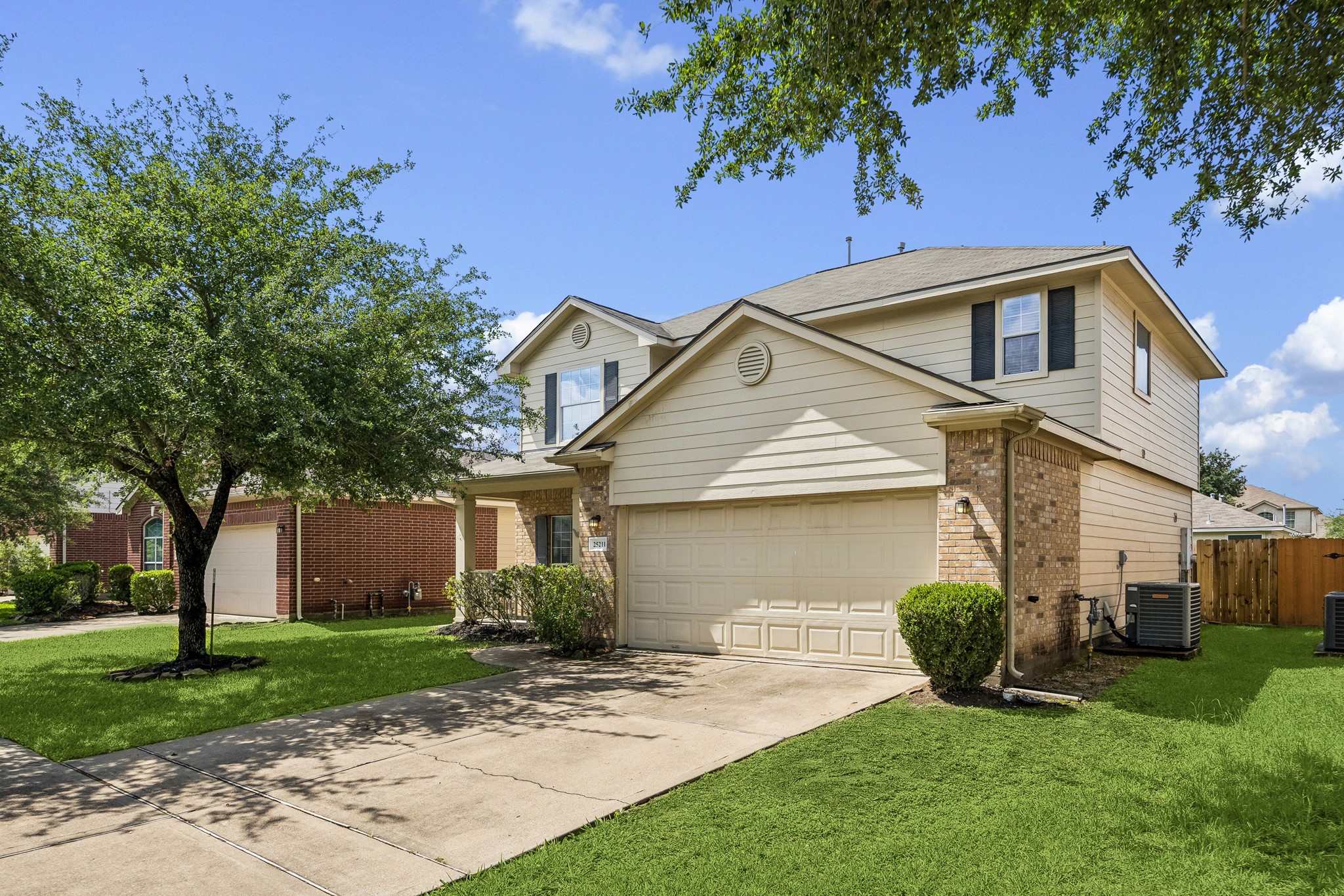 a front view of a house with a yard and trees