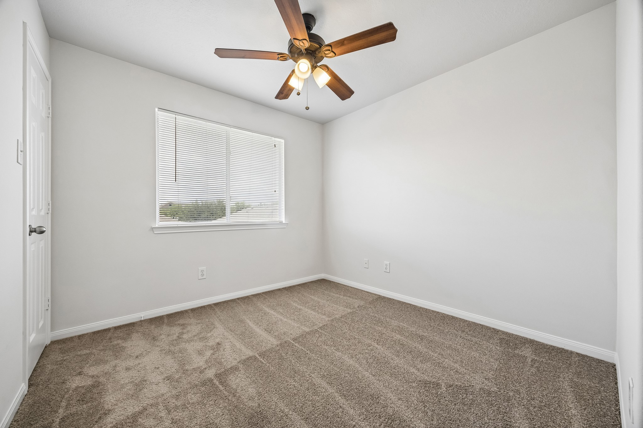 25211 Hazel Ranch Drive Katy, TX 77494 - Photo 4 of 10 an empty room with a window and a fan