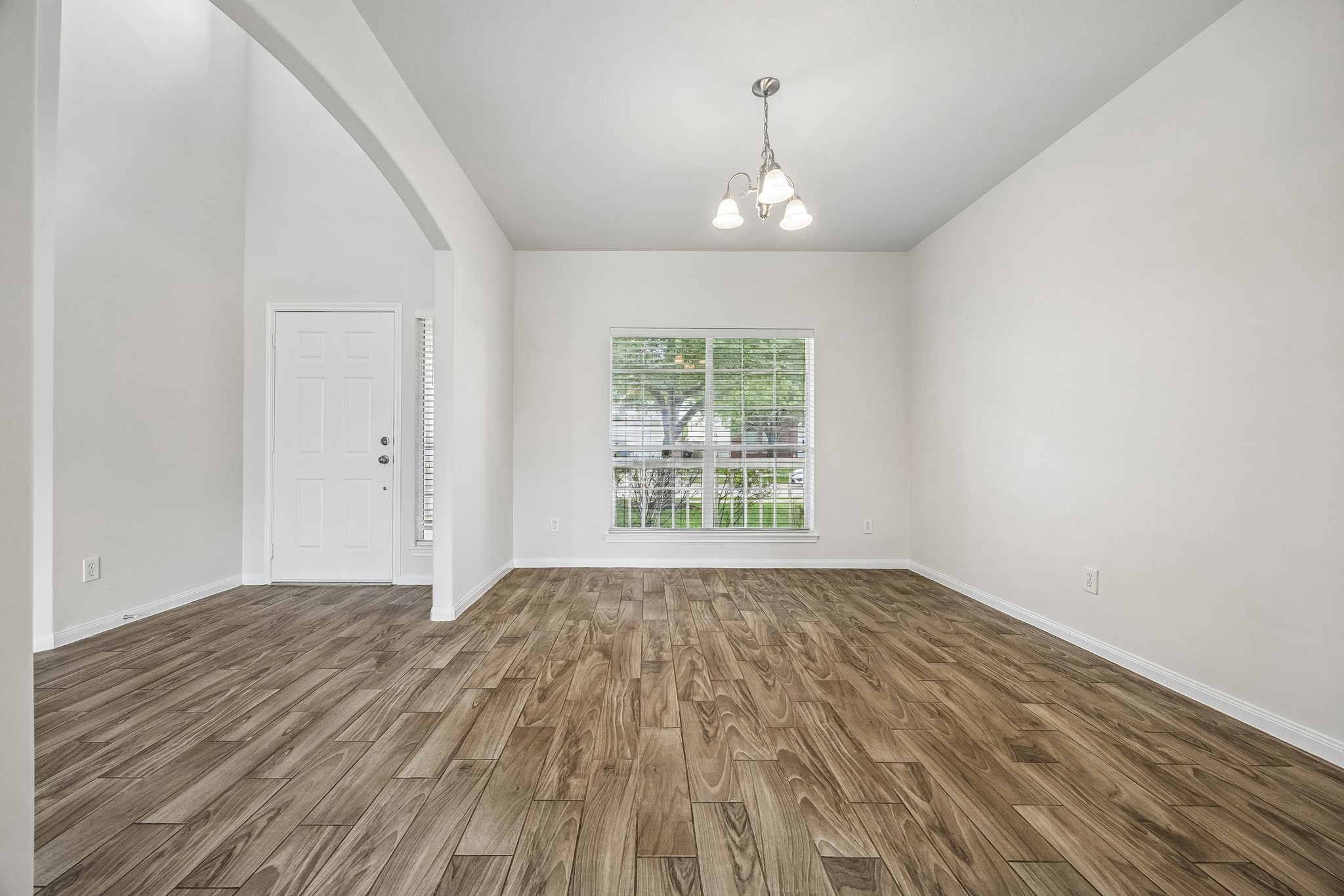25211 Hazel Ranch Drive Katy, TX 77494 - Photo 6 of 10 a view of an empty room with wooden floor and a window