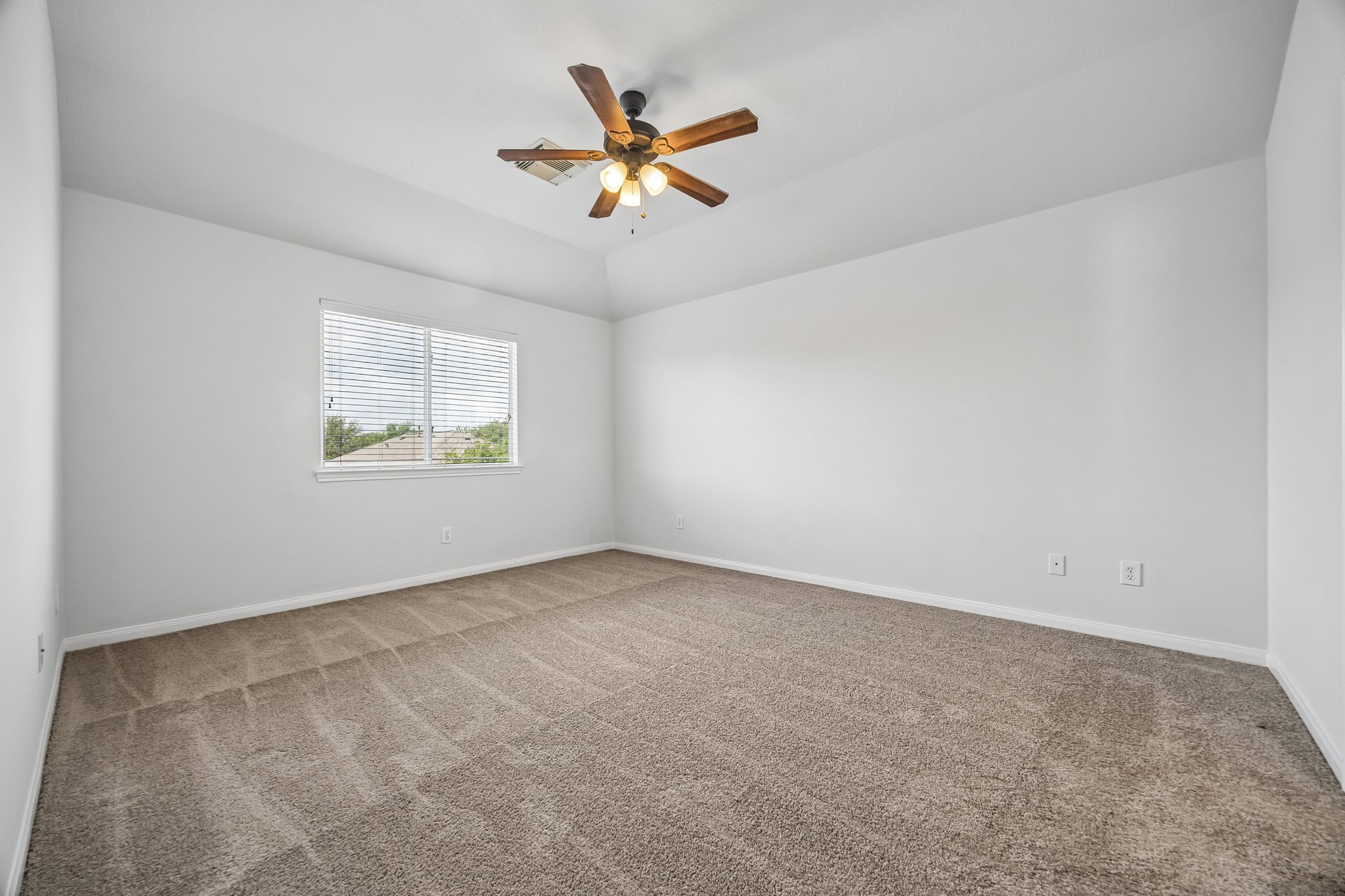 25211 Hazel Ranch Drive Katy, TX 77494 - Photo 7 of 10 an empty room with ceiling fan and windows
