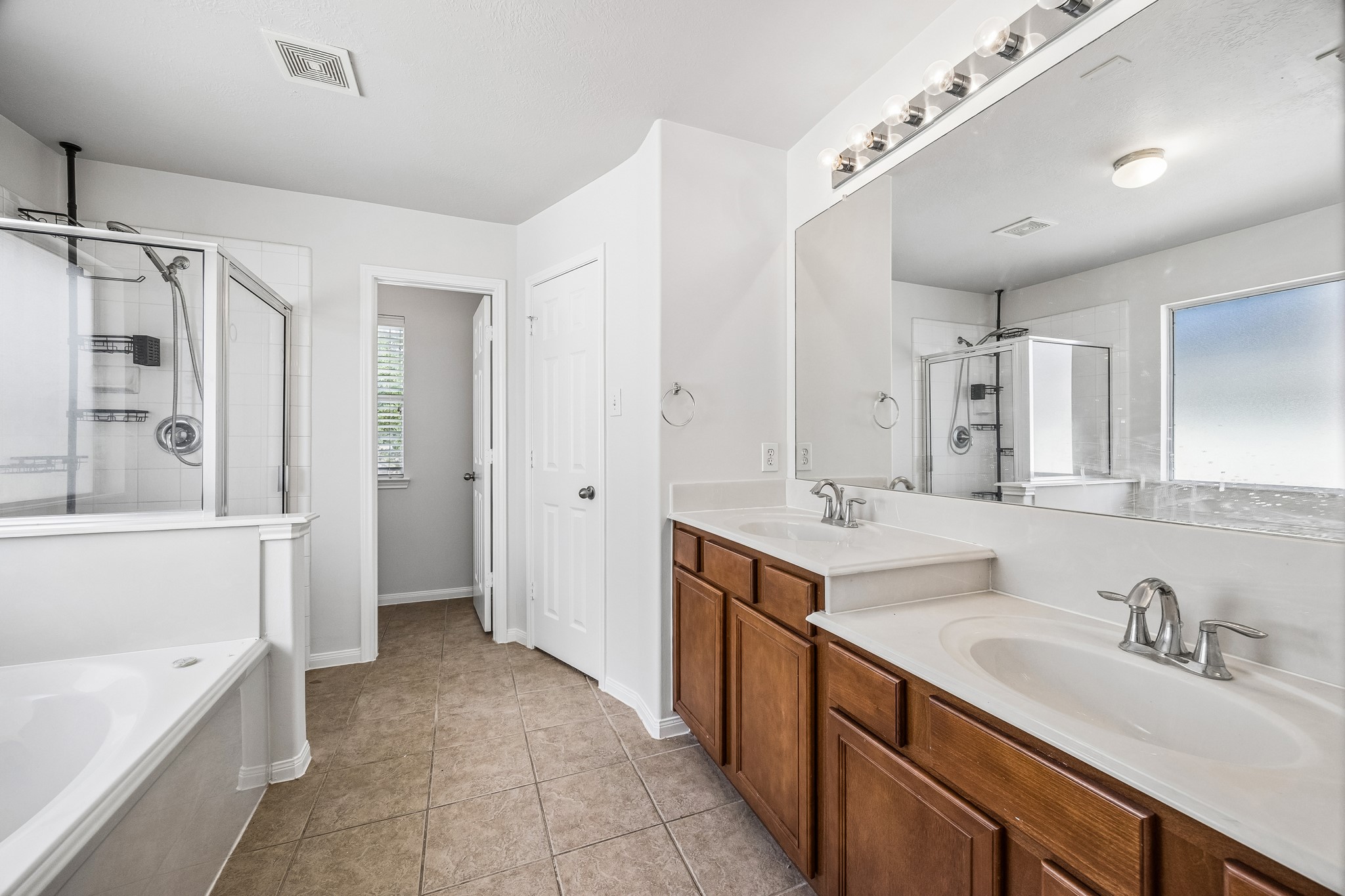 25211 Hazel Ranch Drive Katy, TX 77494 - Photo 8 of 10 a bathroom with a sink double vanity granite tub shower and mirror