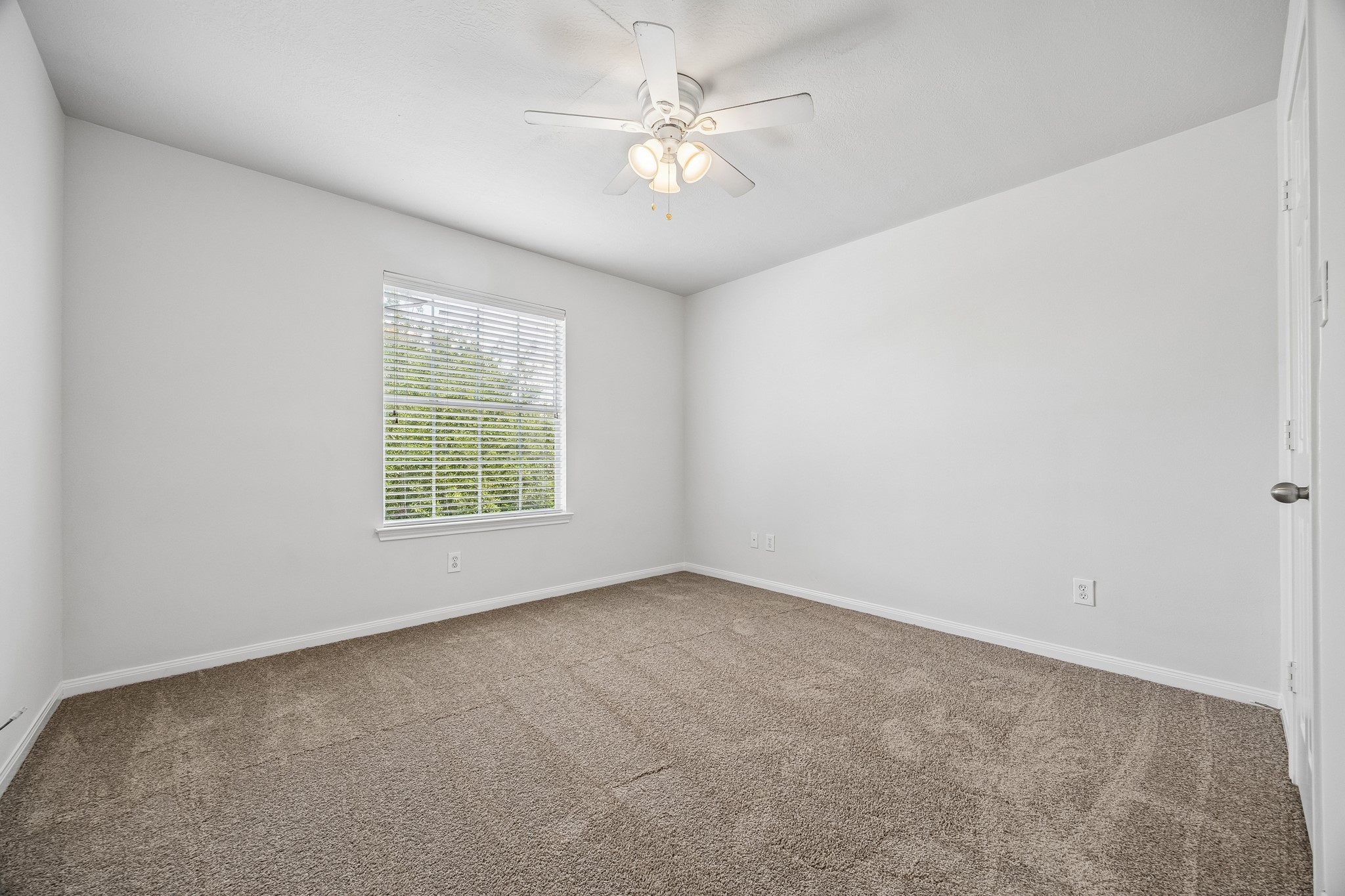 25211 Hazel Ranch Drive Katy, TX 77494 - Photo 9 of 10 an empty room with windows and ceiling fan