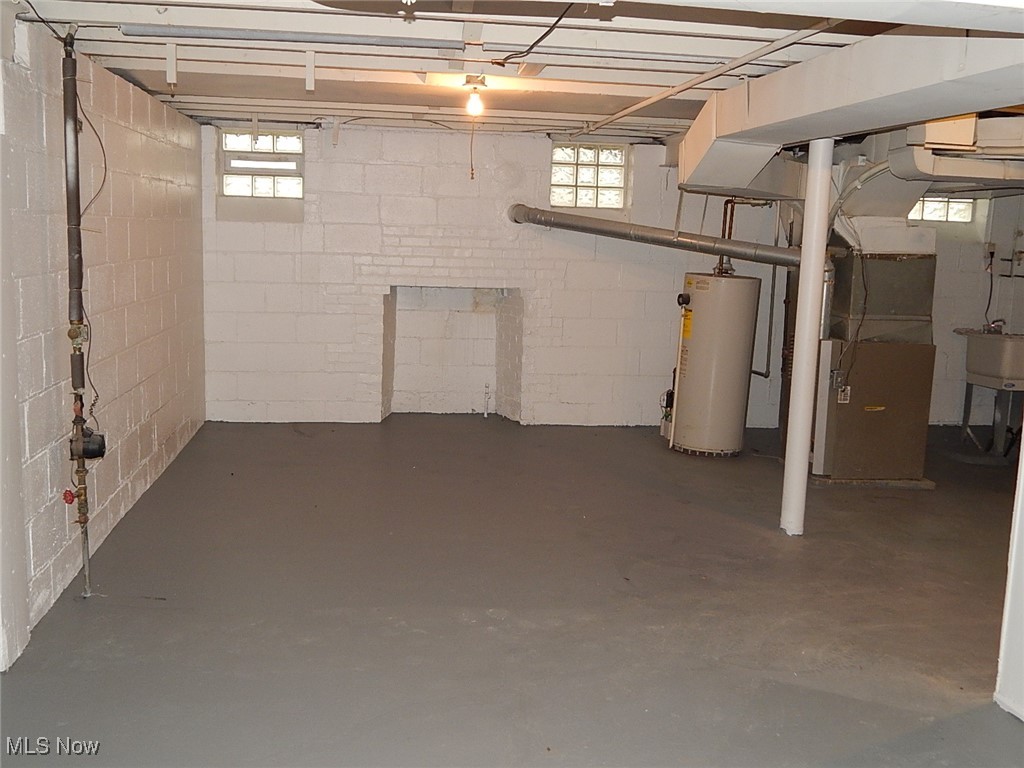 4768 Burleigh Road Cleveland, OH 44125 - Photo 12 of 12 Below grade area featuring water heater, plenty of natural light, and heating unit