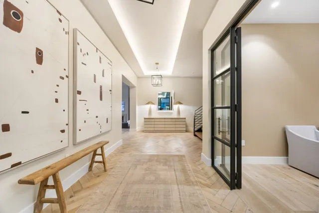 a view of a hallway view with wooden floor and staircase