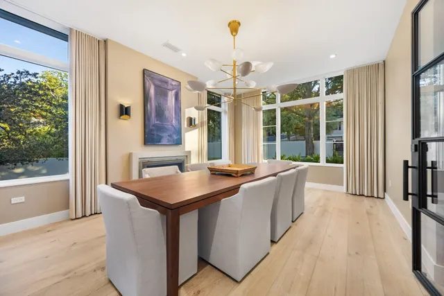 a living room with stainless steel appliances granite countertop furniture and a chandelier