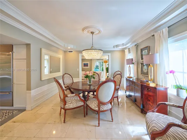 a living room with furniture a couch and a potted plant