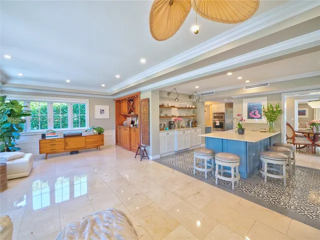 a spacious bathroom with a granite countertop sink a toilet a mirror and shower