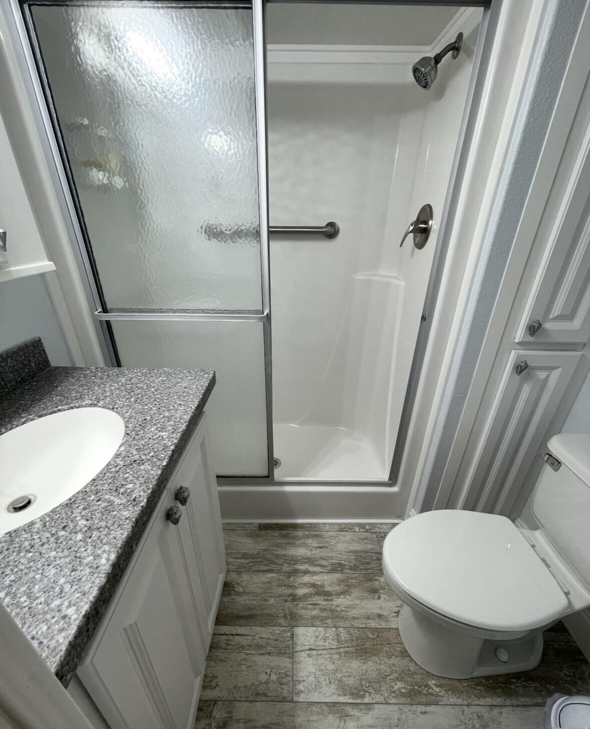 325 Calusa Street, Unit 55 Key Largo, FL 33037 - Photo 8 of 29 a bathroom with a granite countertop sink toilet and shower