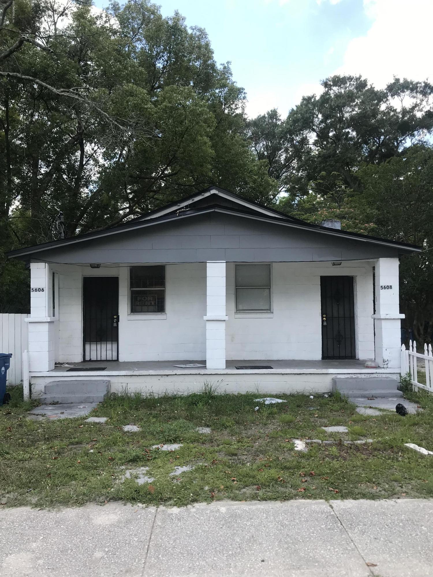 5606 Moncrief Road Jacksonville, FL 32209 - Photo 1 of 26 a view of a backyard with table and chairs and wooden fence