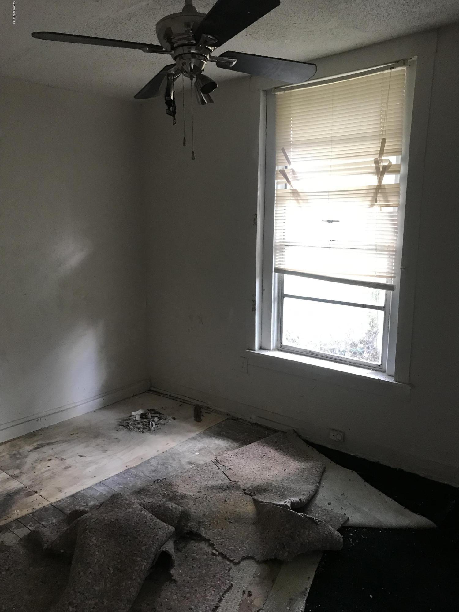 5606 Moncrief Road Jacksonville, FL 32209 - Photo 22 of 26 a bedroom with a bed and a window