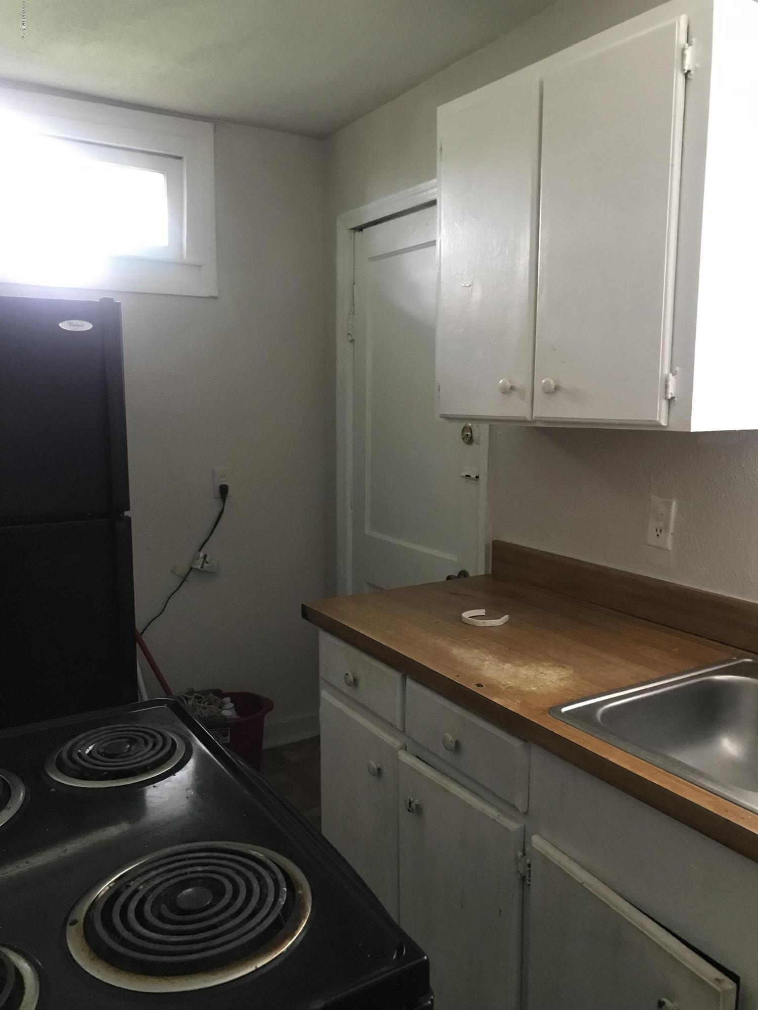 5606 Moncrief Road Jacksonville, FL 32209 - Photo 26 of 26 a kitchen with a sink stove and cabinets